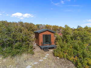 View of outbuilding with a wooded view