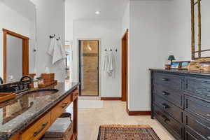 Full bathroom featuring a stall shower, vanity, light tile patterned floors, and recessed lighting