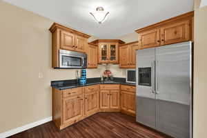 Kitchenette  with stainless steel refrigerator just needing a small stove to be a full kitchen