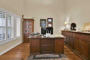 Office featuring hardwood  flooring, vaulted ceilings, -plantation shutters  and french doors
