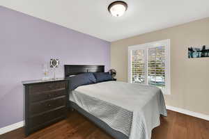 Bedroom 2  featuring hardwood floors and plantation shutters.