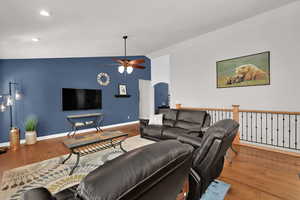 Great room with, vaulted ceilings sliding door to backyard, plantation shutters and gas fireplace