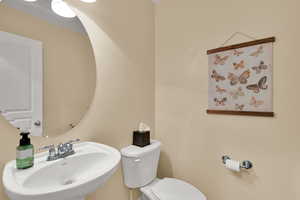 Half bathroom between the kitchen and the garage