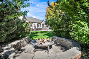 View of patio with an outdoor fire pit