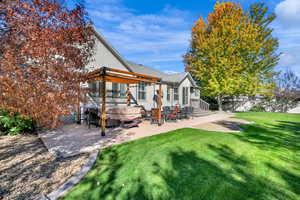 Back of house featuring fully fenced yard, vinyl fencing, a patio, fire pit, RV parking and storage shed