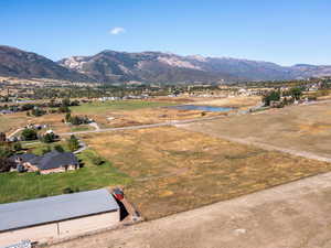 View of mountain background featuring a large body of water and rural landscape