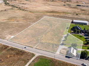 Aerial view of sparsely populated area featuring property parcel outlined