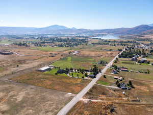 Aerial view of property and surrounding area featuring a water and mountain view and rural landscape