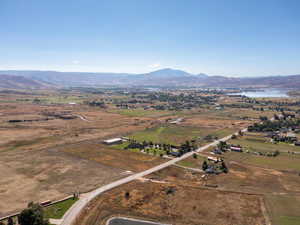 Aerial view of property and surrounding area with a water and mountain view and rural landscape