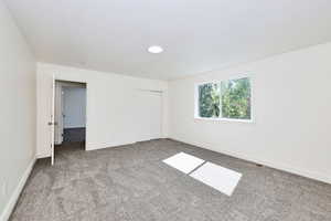 Unfurnished bedroom with carpet and a closet