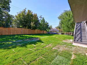 Fenced backyard with stairs