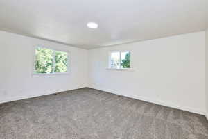 Unfurnished room with baseboards and carpet floors