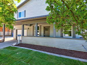 View of front facade featuring covered porch, an attached garage, and concrete driveway