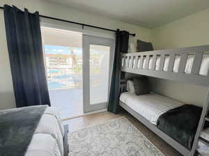 Bedroom featuring light tile patterned floors and access to exterior