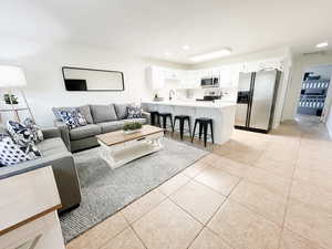 Living area with light tile patterned flooring