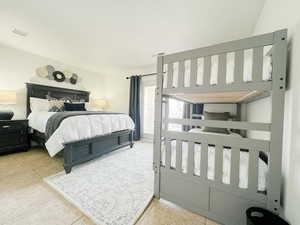 Bedroom with light tile patterned floors