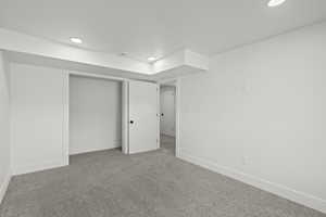 Below grade area with carpet floors and recessed lighting