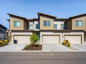Craftsman house featuring driveway, an attached garage, and board and batten siding