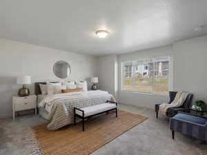 Carpeted bedroom featuring a textured ceiling and baseboards
