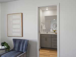Half bathroom featuring light wood-style flooring and vanity