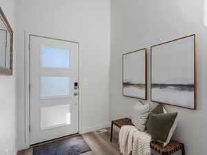 Entryway with wood finished floors and baseboards