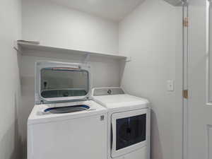 Washroom with washer and clothes dryer