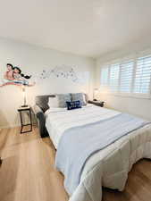 Bedroom featuring wood finished floors and baseboards