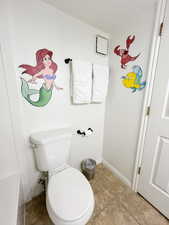 Bathroom with toilet and light tile patterned floors