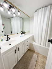 Full bath featuring vanity and shower / tub combo with curtain
