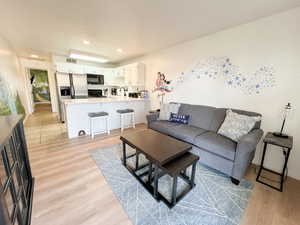 Living area featuring light wood-style flooring and recessed lighting