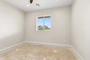 Empty room with ceiling fan and recessed lighting