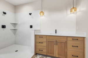 Full bath featuring vanity and a shower