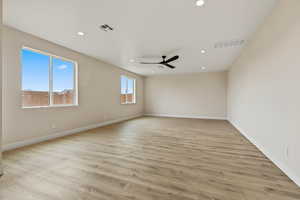 Spare room with light wood-style floors, recessed lighting, and a ceiling fan