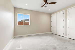 Unfurnished bedroom with ceiling fan, a closet, concrete floors, and recessed lighting