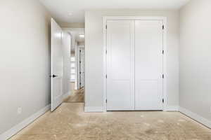 Unfurnished bedroom featuring a closet and baseboards