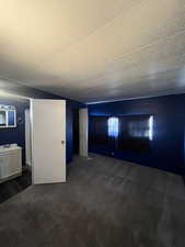 Unfurnished living room with dark colored carpet