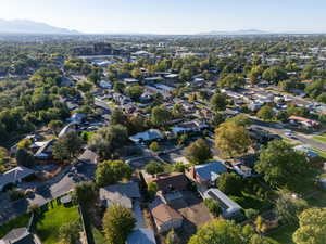 Aerial overview of property's location with mountains and nearby suburban area