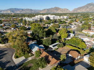 Aerial view of property's location featuring mountains and nearby suburban area
