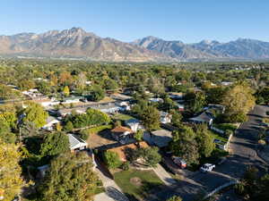 Aerial view of property's location featuring a mountain backdrop and nearby suburban area