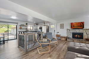 Living room with LVT and a stone fireplace