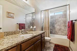 Full bathroom featuring shower / bath combo, vanity, and light tile patterned floors
