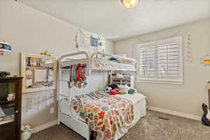 Carpeted bedroom featuring baseboards