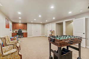 Game room featuring recessed lighting, a desk, and light colored carpet