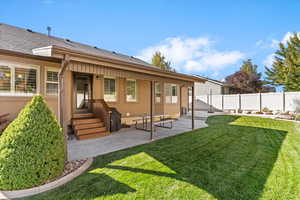 Back of property featuring a patio, a shingled roof, and stucco siding