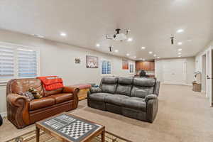 Living room with light colored carpet and recessed lighting