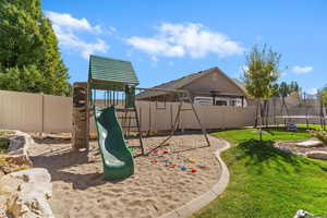 View of jungle gym featuring a fenced backyard and a trampoline