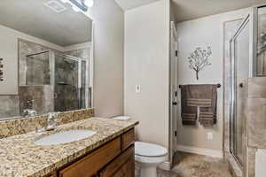 Full bath with a stall shower and vanity