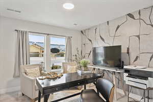 Carpeted office space with baseboards