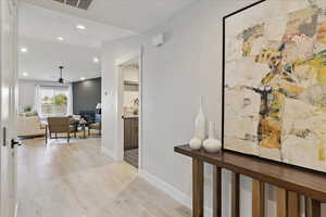 Corridor with recessed lighting and light wood-type flooring