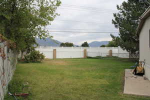 Fenced backyard with a mountain view